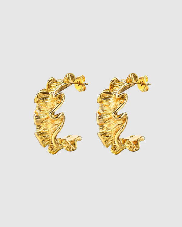 Textured, bold, and effortlessly chic—the Castel & Co Crinkle Earrings in Gold bring a sculptural edge to classic jewellery. Their organic, rippled design reflects light beautifully, creating a statement that feels both modern and timeless. Perfect for adding depth to minimal looks or enhancing an already bold ensemble, these earrings offer a sophisticated yet playful finish to any outfit.

Main material: gold plating, stainless steel
Closure type: stud
Earrings size: 3 x 1,5 cm
Waterproof/ hypoallergenic