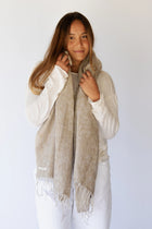 Meet the layer you’ll reach for repeatedly. Worn as a shawl, wrap or scarf, this timeless piece moves effortlessly from slow mornings to cool evenings. Cosy yet refined, it’s made for early yoga flows, windswept beach sunsets, and everything in between.

Lightweight but warming, it’s the ultimate travel companion - wrapping you in comfort and that familiar, at-home feeling wherever you land.

Available in: Mulberry &amp; Hazelnut.

Details
• Approx. 76cm x 188cm
• Cool hand-wash, dry with care
• Handwoven i