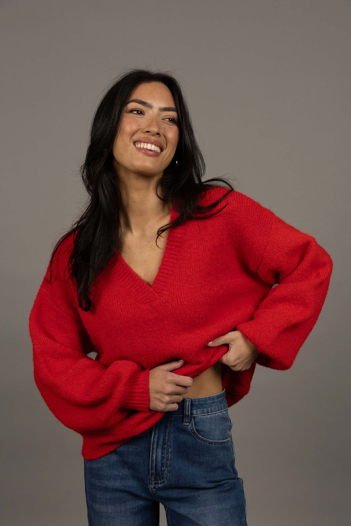 Humidity Lifestyle Nouveau V Neck Jumper in a soft wool blend, featuring a relaxed, oversized fit with a low V-neckline and subtle bell sleeves. Designed with ribbed cuffs and hem that sit just below the hips, this plush, lightweight jumper has a gentle, fluffy texture ideal for layering over denim or dresses.
