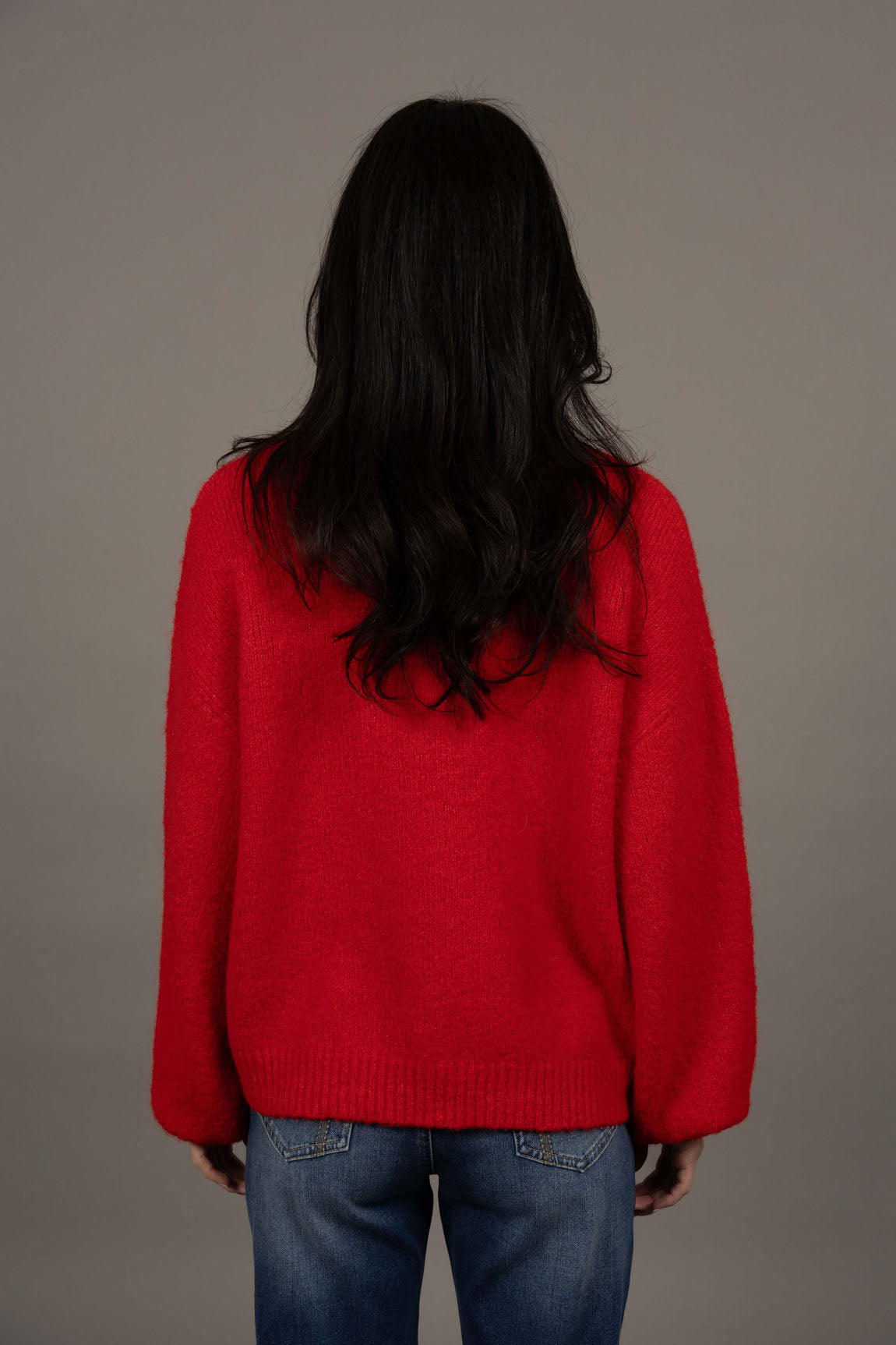 Humidity Lifestyle Nouveau V Neck Jumper in a soft wool blend, featuring a relaxed, oversized fit with a low V-neckline and subtle bell sleeves. Designed with ribbed cuffs and hem that sit just below the hips, this plush, lightweight jumper has a gentle, fluffy texture ideal for layering over denim or dresses.