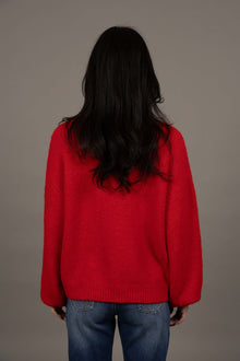 Humidity Lifestyle Nouveau V Neck Jumper in a soft wool blend, featuring a relaxed, oversized fit with a low V-neckline and subtle bell sleeves. Designed with ribbed cuffs and hem that sit just below the hips, this plush, lightweight jumper has a gentle, fluffy texture ideal for layering over denim or dresses.