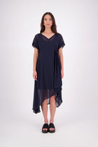The NES Kira Dress blends the best of two favourites – the elegance of the Dreamliner and the versatility of the Flow Dress. With a relaxed drape and subtle tailoring, it features a flattering V-neckline, rouching under the bust on one side, cap sleeves, and adjustable button loop detailing for styling versatility (one dress - wear it 3 ways).