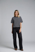 NES DollyB Denim Pants by N-E-S – a wide-leg stretch denim pant with fold-down rib waistband and contrast stitching. Available in blue or black denim. NZ made.
