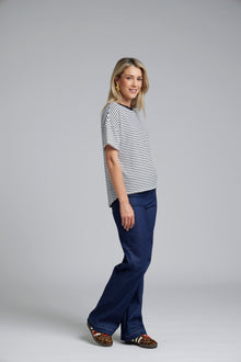NES DollyB Denim Pants by N-E-S – a wide-leg stretch denim pant with fold-down rib waistband and contrast stitching. Available in blue or black denim. NZ made.