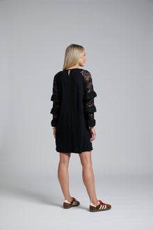 NES Luxa Dress by N-E-S – a black merino dress with sculptural ruffled lace sleeves, subtle gathers and above-knee length. Bold, modern and NZ made.