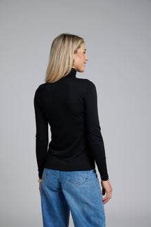 The NES Merino Funnel Neck Top by N-E-S. A warm, soft 100% merino layer with funnel neckline and long sleeves. Wear alone or layered. Winter essential. NZ made.