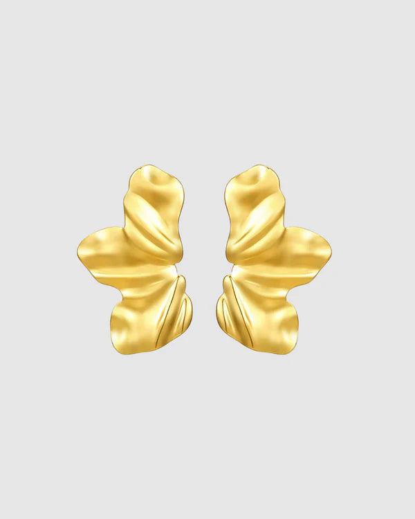 Sculptural and dramatic, the Castel & Co Sienna Earrings feature fluid, folded curves in radiant gold plating. Their bold silhouette and organic form create a striking sense of movement, designed to frame the face with modern artistry. A statement earring that embodies elegance with an edge.

Material: Stainless steel, Gold plating
Closure Type: Stud
Earrings Size: 4.5 x 2.5 cm
Waterproof and hypoallergenic
Weight: 7g