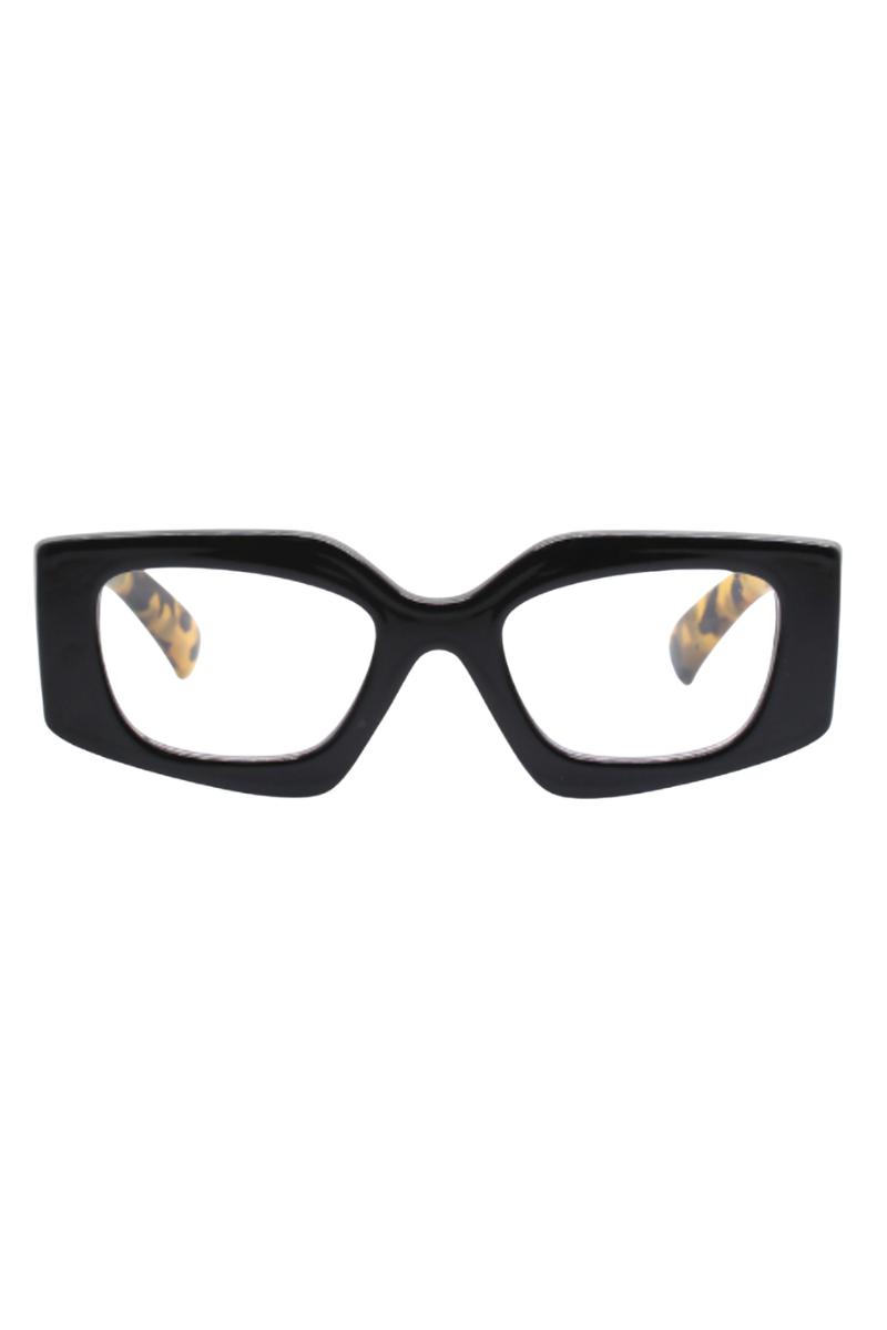 REALITY EYEWEAR
Shelley Reader brings a bold, fashion-forward edge to everyday eyewear. Defined by its striking geometric silhouette, this statement shape is balanced by a sleek black front for a look that feels both modern and timeless. The standout detail? Sculptural leopard-print arms that add just the right amount of attitude and contrast.