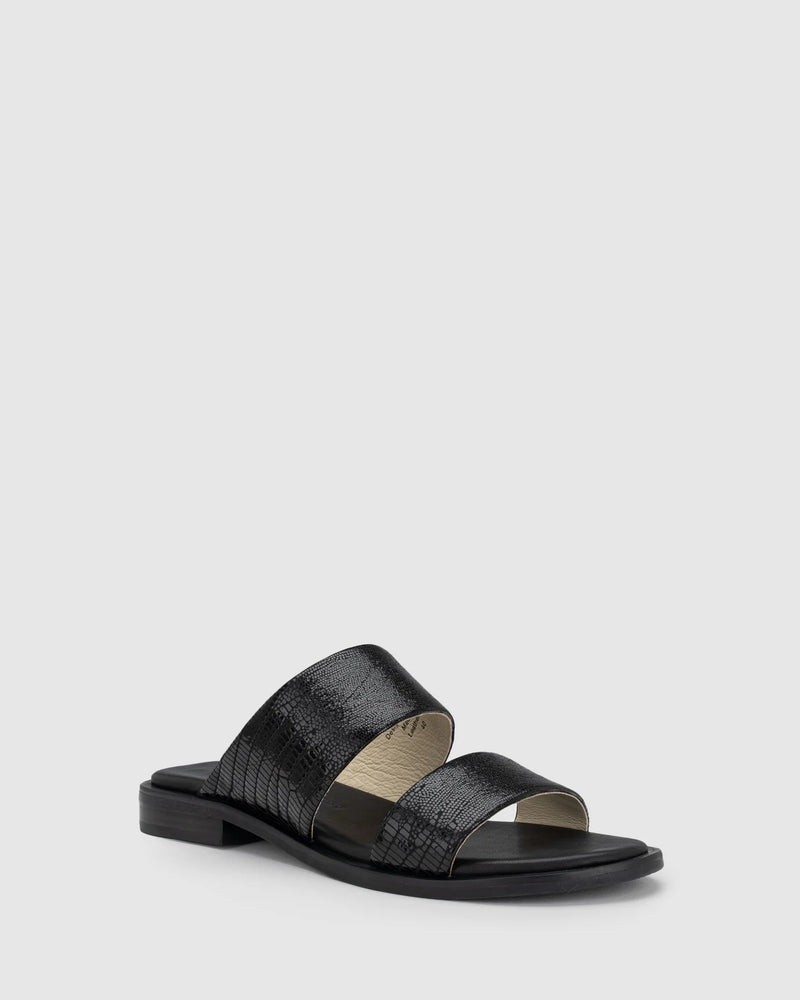 CHAOS &amp; HARMONY | WAVE SLIDE

The WAVE SLIDE in Black Snake features a subtle embossed texture that adds interest to its minimalist form. Designed as a go-to flat leather slide, it’s ideal for everyday wear — clean, easy, and comfortable from the ground up.

Black snake embossed leather slide
Soft leather lined
Black stack heel / black rubber outsole
20mm / 0.78 inch heel
Standard fit
We recommend a good leather/suede protectant to protect your shoes
Made in Dongguan, China